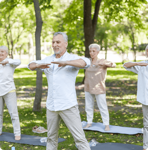 Group of elderly people practicing Tai Chi together in a park