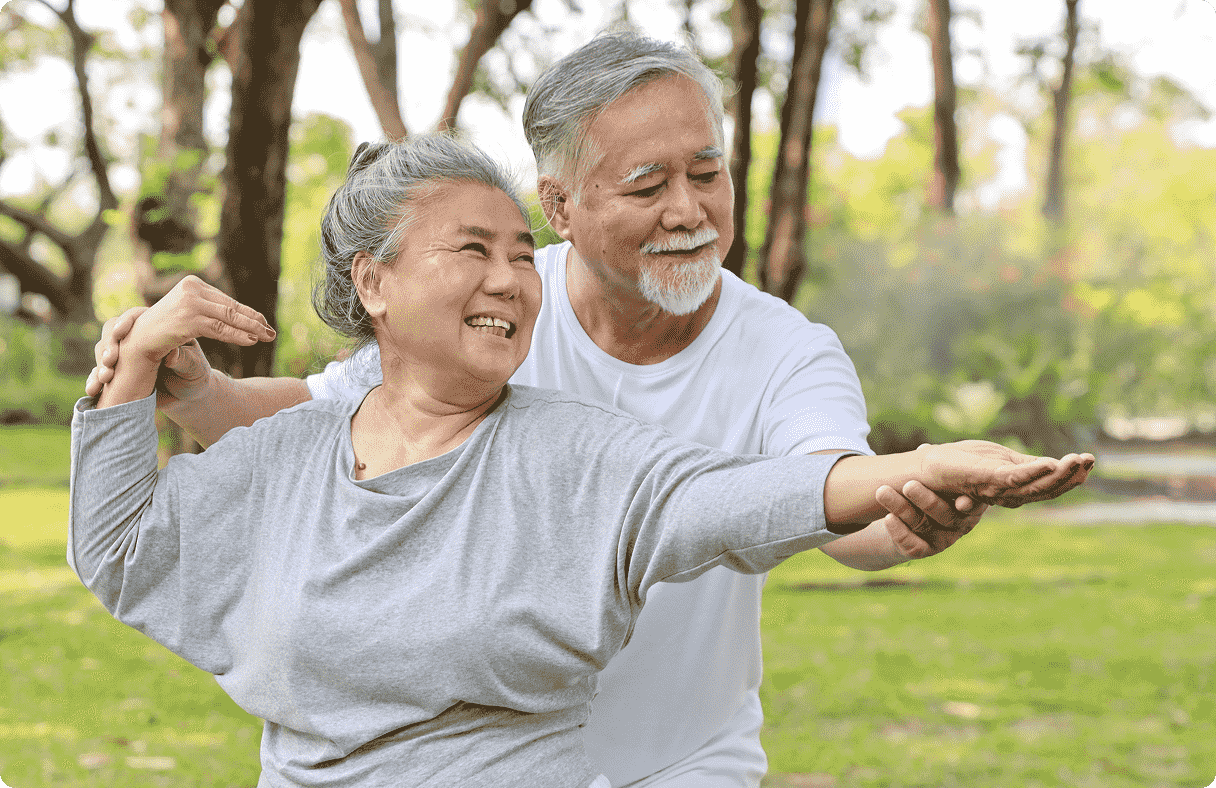 Elderly couple practicing Tai Chi in park